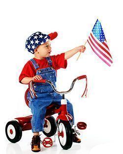 Boy on his bike waving the USA flag